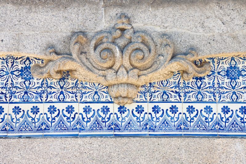 Typical Portuguese decorations with colored ceramic tiles and baroque carved frame
