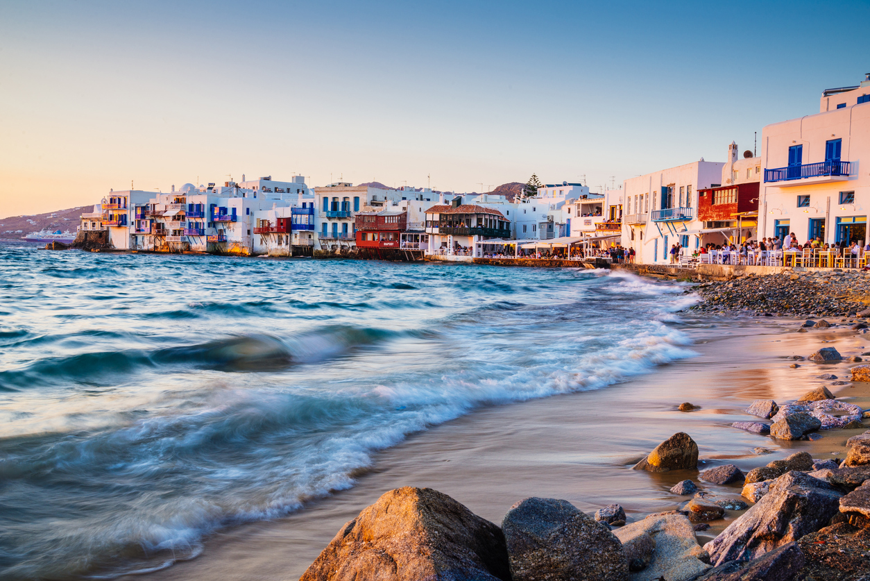 Rolling waves and sunset dining at famous Mykonos neighborhood of Little Venice, Mykonos, Greece