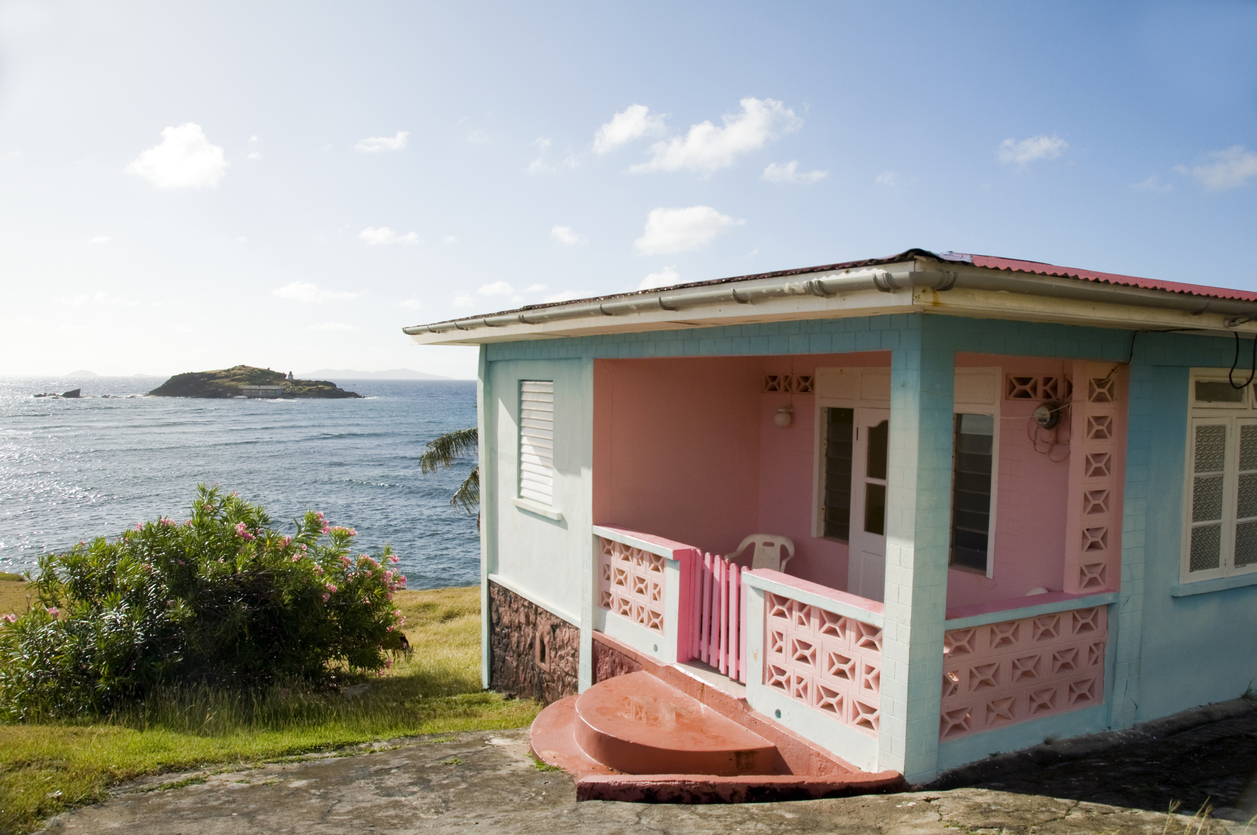 typical colorful caribbean style house in bequia st. vincent and the grenadines islands waterfront caribbean sea