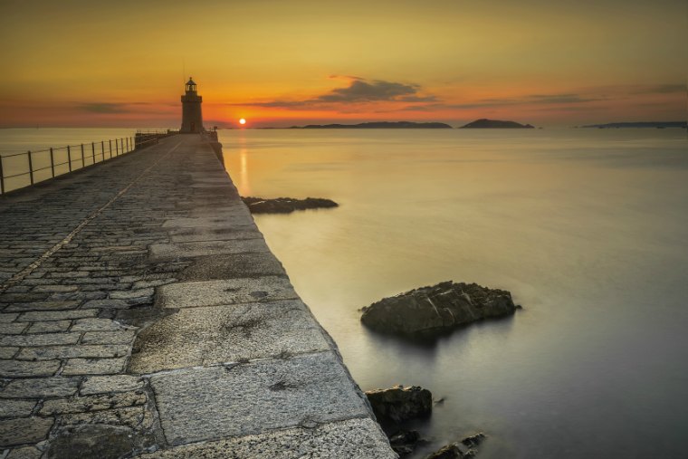 The sunrises over herm, taken from castle cornet break water, St Peter Port, Guernsey Channel Islands