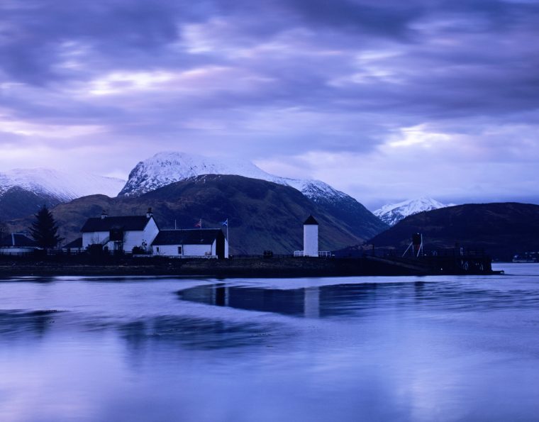 The quayside and cottages at Corpach, near Fort William, Argyll, at daybreak. shot in February, with snow on the mountains behind