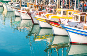 Colorful sailing boats at Fishermans Wharf of San Francisco Bay