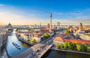 Aerial view of Berlin skyline with famous TV tower and Spree river in beautiful evening light at sunset, Germany